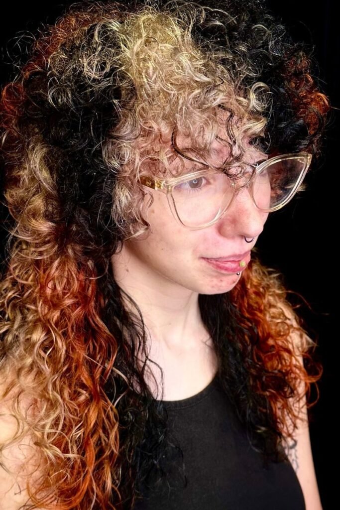 Curly layered Medusa style with black and blonde highlights