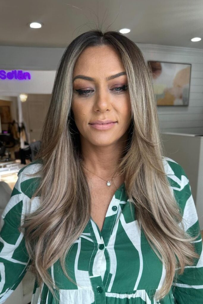 Long layered cut with ashy blonde and face-framing layers
