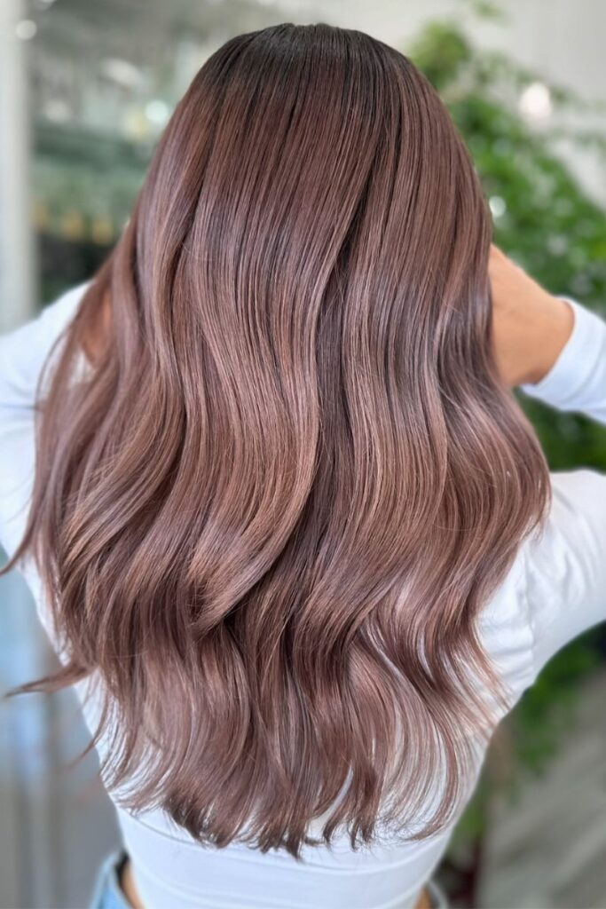 Long wavy dusty rose-brown hair with soft waves middle part