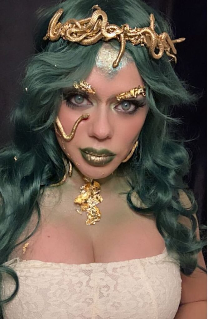 Medusa-inspired green wavy hair with golden snake headpiece and dramatic makeup