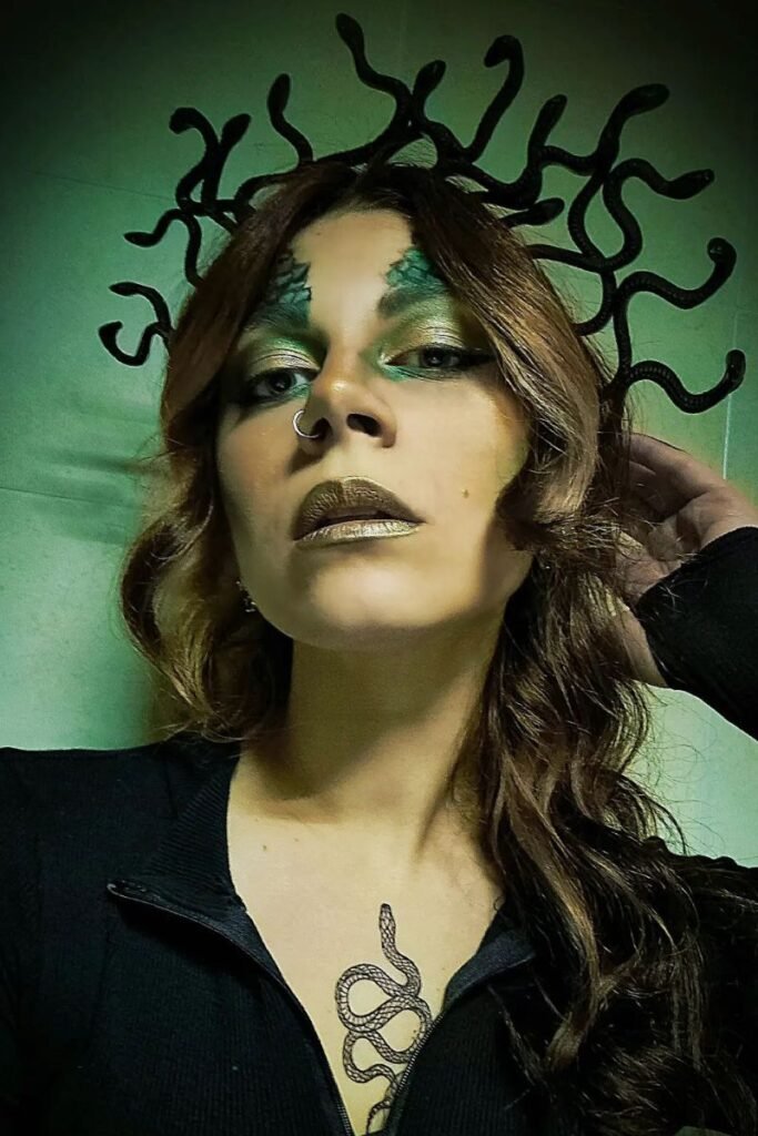 Medusa snake crown with loose waves and green serpent makeup