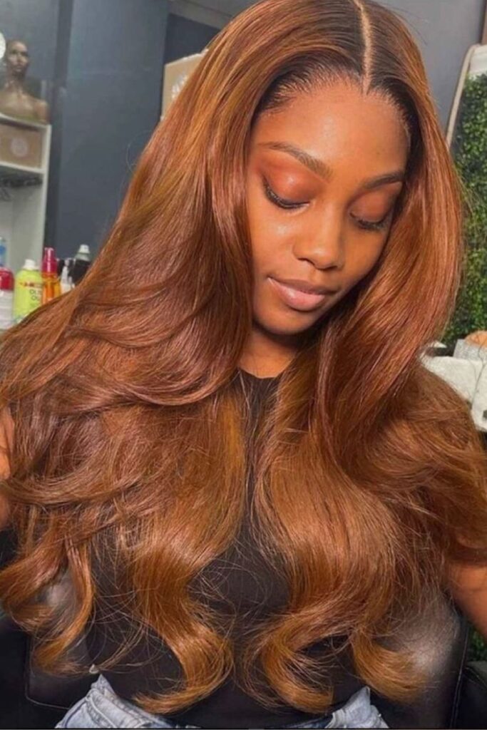 Rich auburn layered blowout with voluminous curls