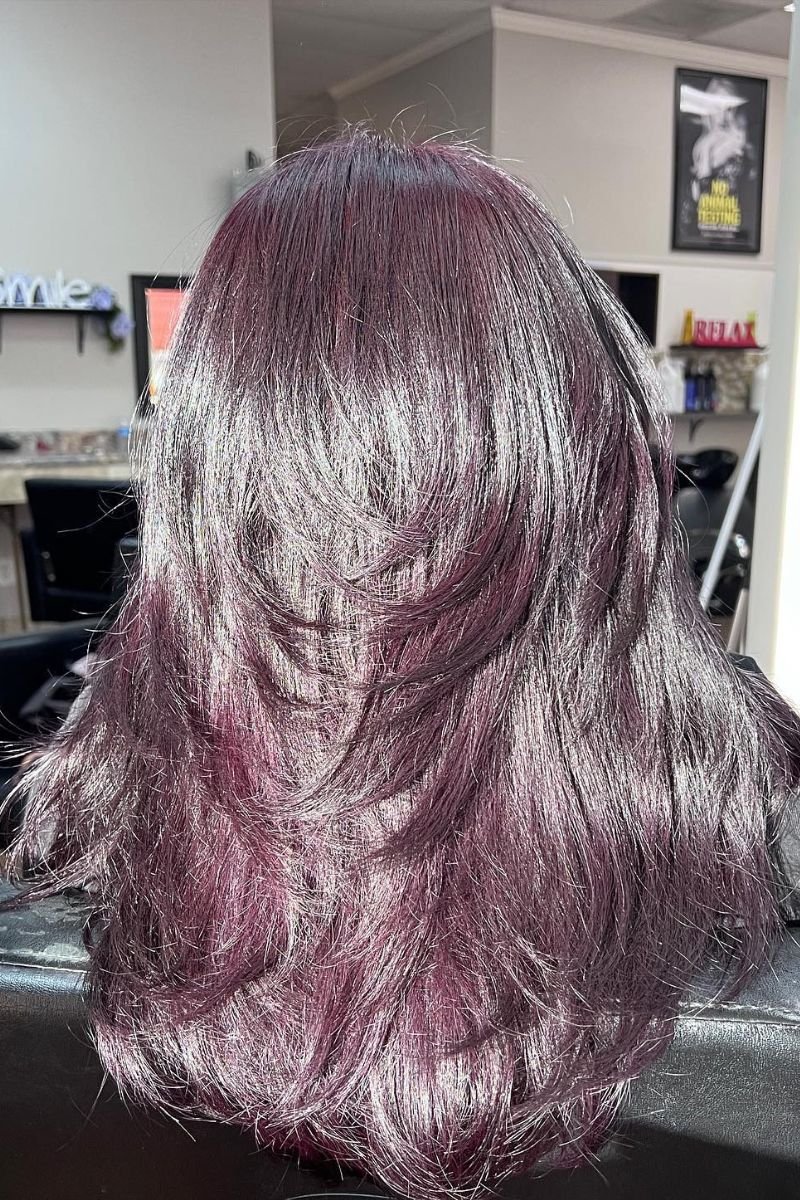 layered hair dyed in shades of purple and black