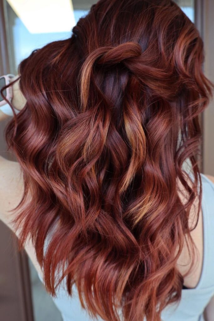 Wavy medium-length cut with copper red and golden highlights