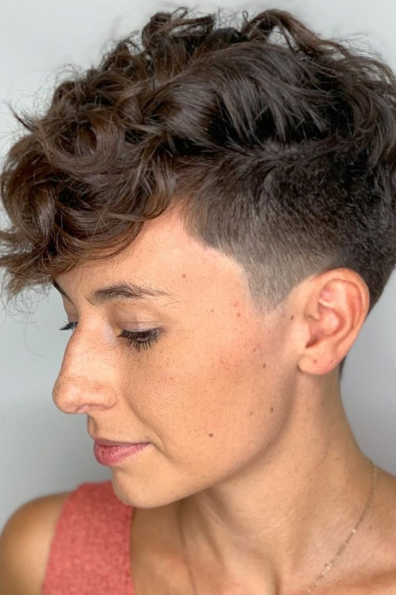 curly pixie cut with short hair on the back and sides, and longer, curly hair on top