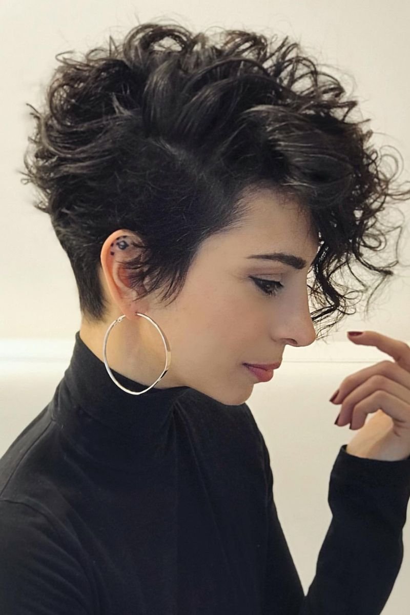 curly pixie cut with tight, defined curls that are closely cropped to the head