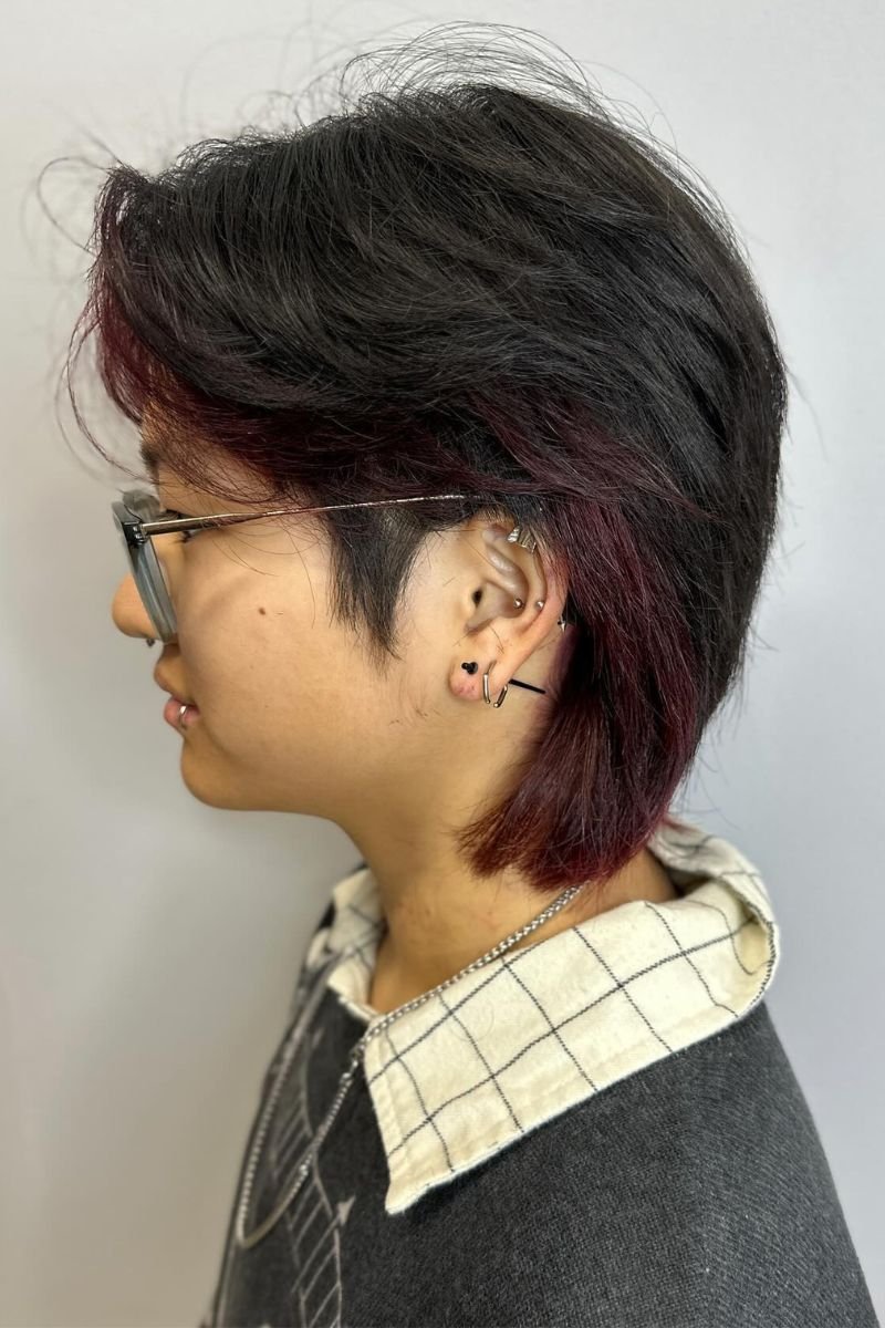 short wolf cut with layered texture and volume on top that tapers down to thinner ends