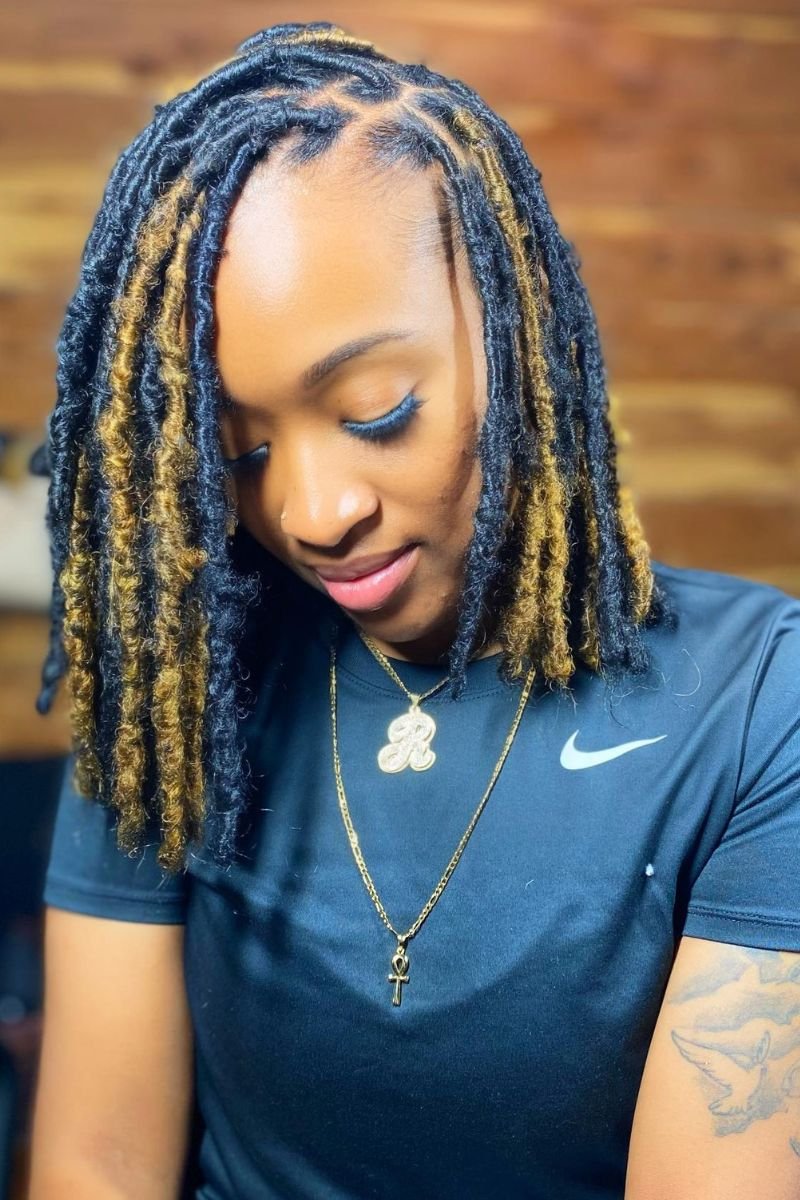 soft locs styled in a bob cut with light brown highlights