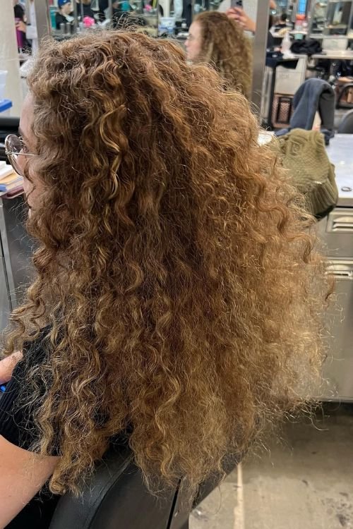 Curly wolf cut with soft layered curls and natural volume