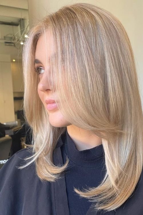 Long layered blonde cut with face-framing soft layers