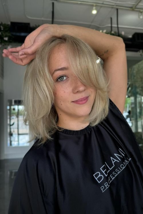 Old money blonde layered bob with curtain bangs