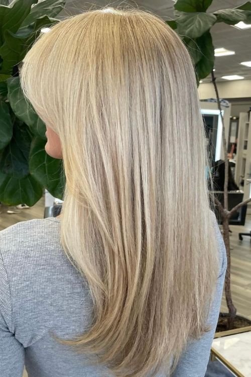 Old money blonde long layered cut with curtain bangs