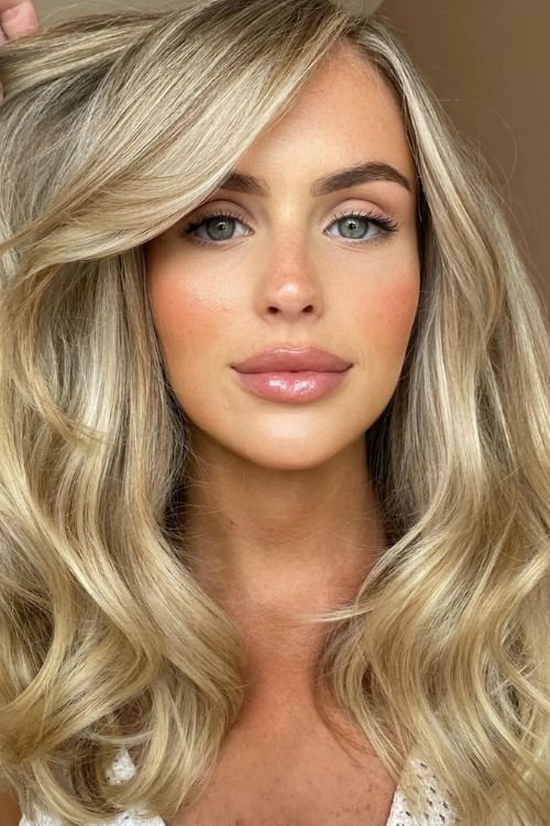 Old money blonde soft waves side part face-framing layers