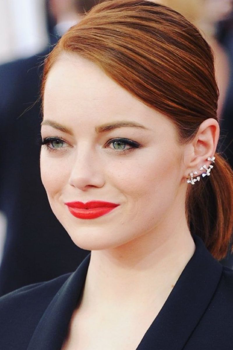 Sleek low ponytail with deep side part.