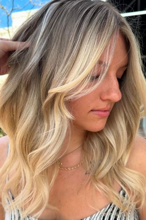 Soft wavy blonde with curtain bangs