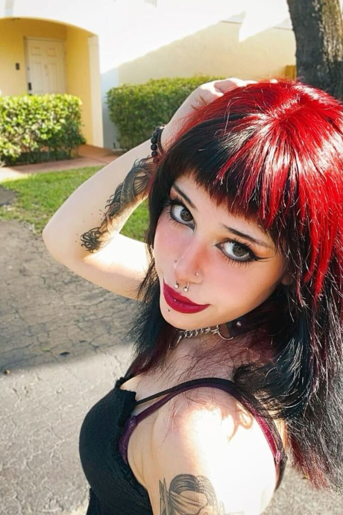 bold shag cut with blunt micro bangs and colored layers.