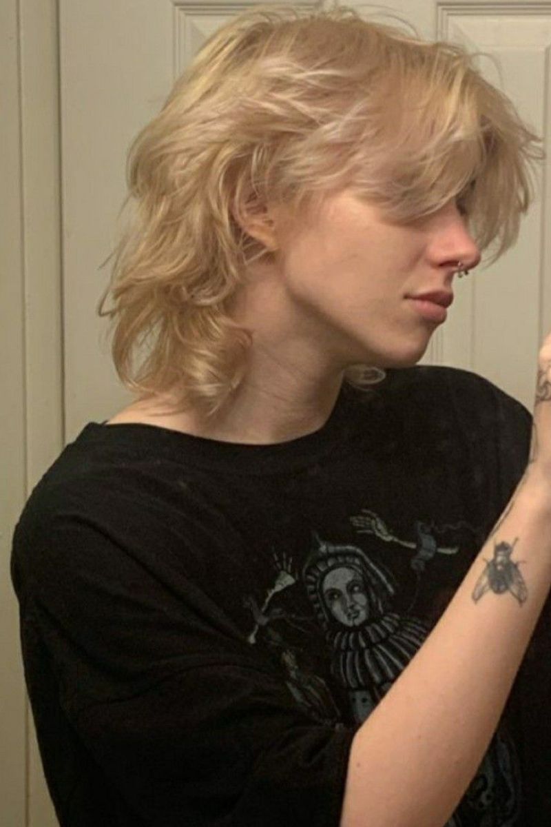 combination of the wolf cut's choppy layers and soft curtain bangs