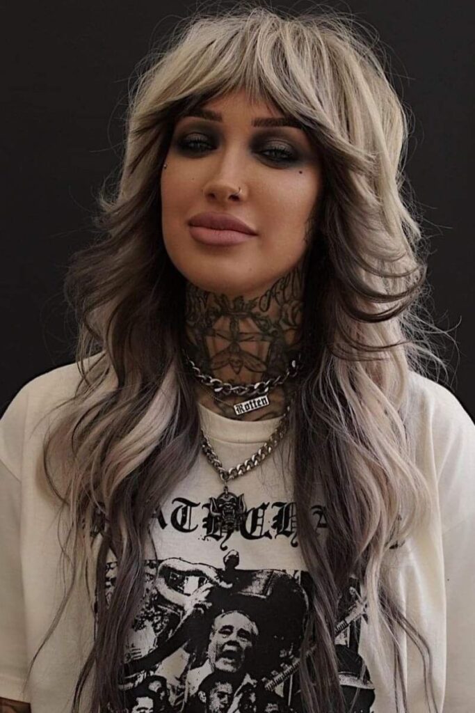 long shag cut with layered, face-framing waves and blunt bangs