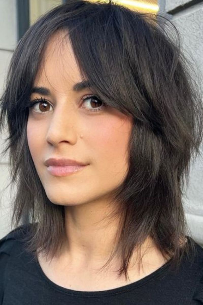 wolf cut with curtain bangs on layered syrup brown bob hair