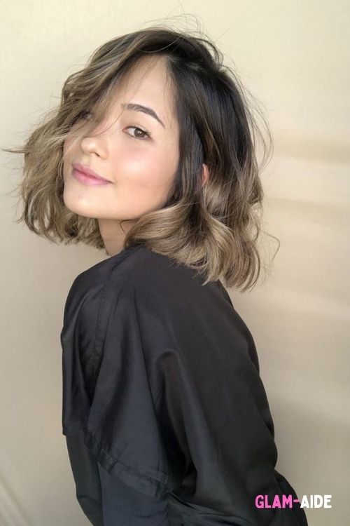 Choppy layered bob with tousled waves and soft balayage