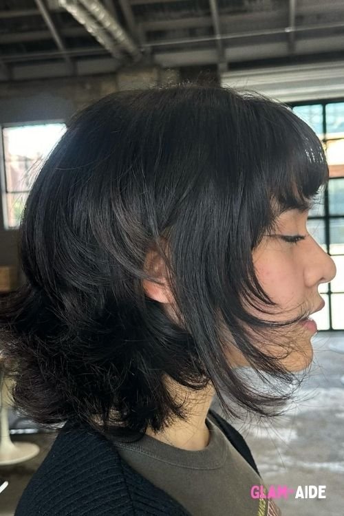 Razor cut bob with flipped-out ends and wispy bangs