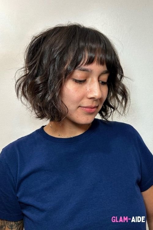 Wavy razor cut bob with wispy bangs and textured layers